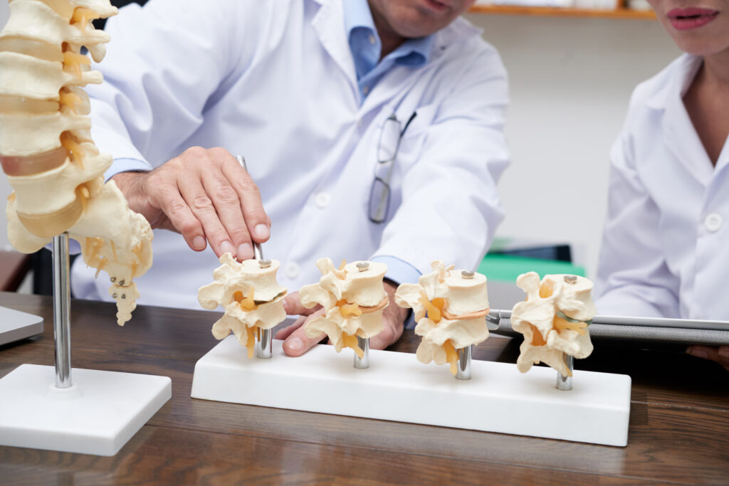 Dr. Yasmeh explaining spine anatomy to a patient