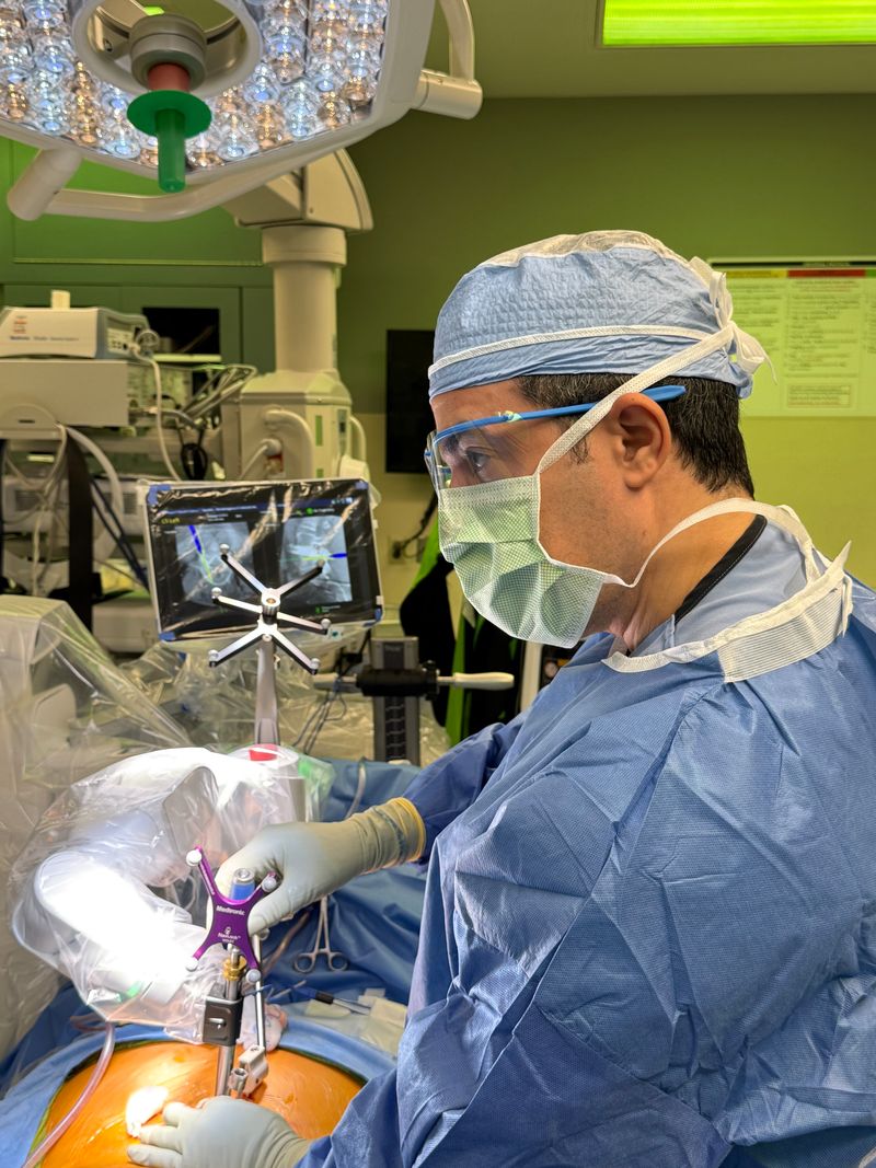 Dr. Yasmeh performing robotic-assisted spine surgery
